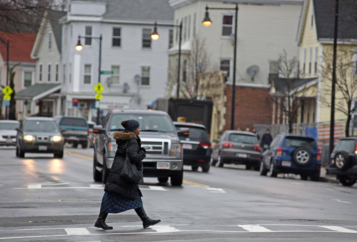 An unidentified woman crosses the intersection at Hyde Park Ave. and West Street.